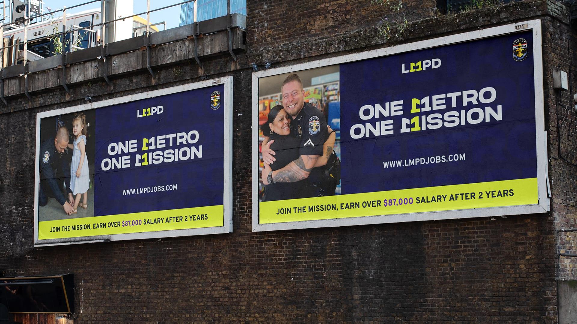Two One Metro One Mission billboards on a brick railway wall